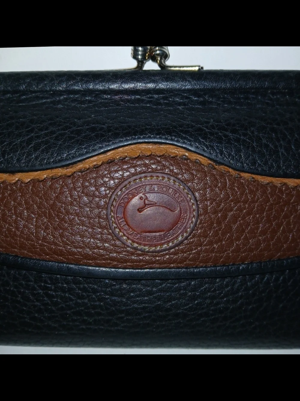 The Dooney & Bourke Black Brown Leather Kisslock Framed Credit Card Trifold